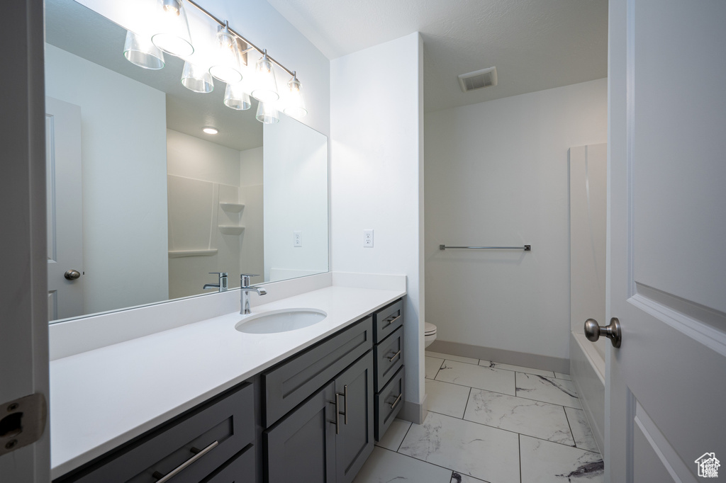 Bathroom featuring vanity and toilet