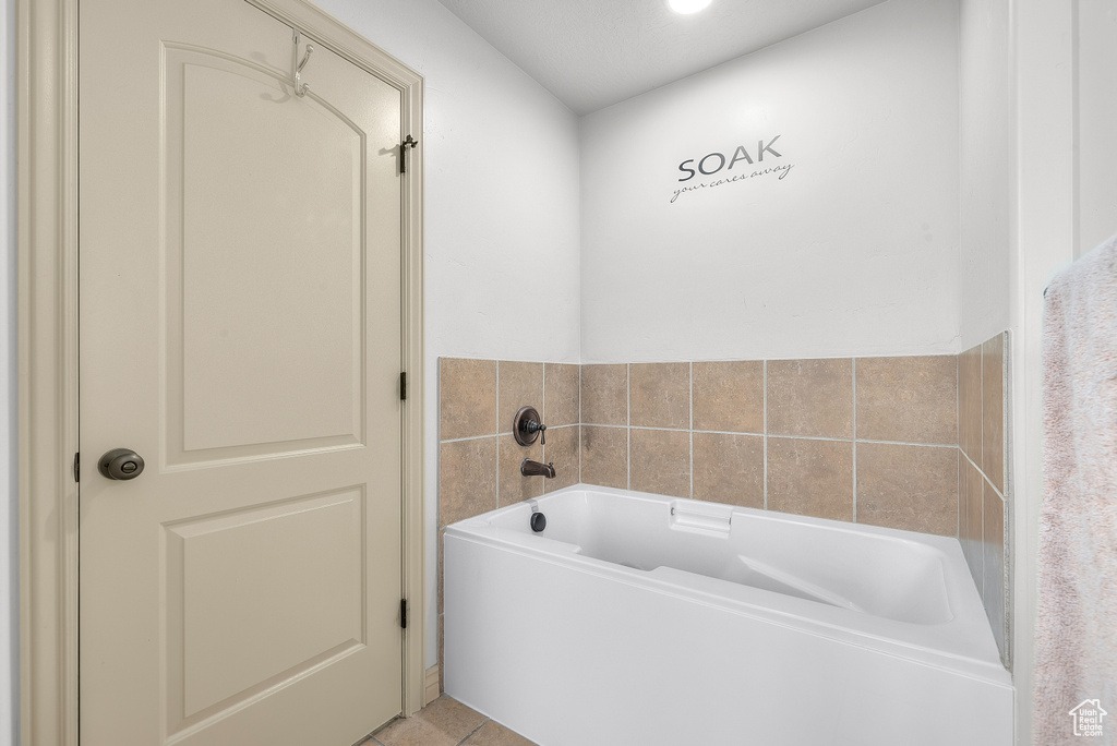 Bathroom featuring a tub to relax in and tile patterned floors