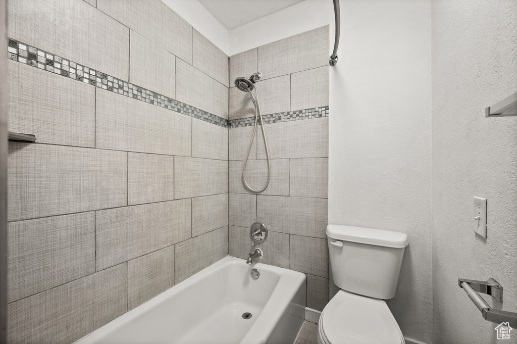 Bathroom with toilet and tiled shower / bath