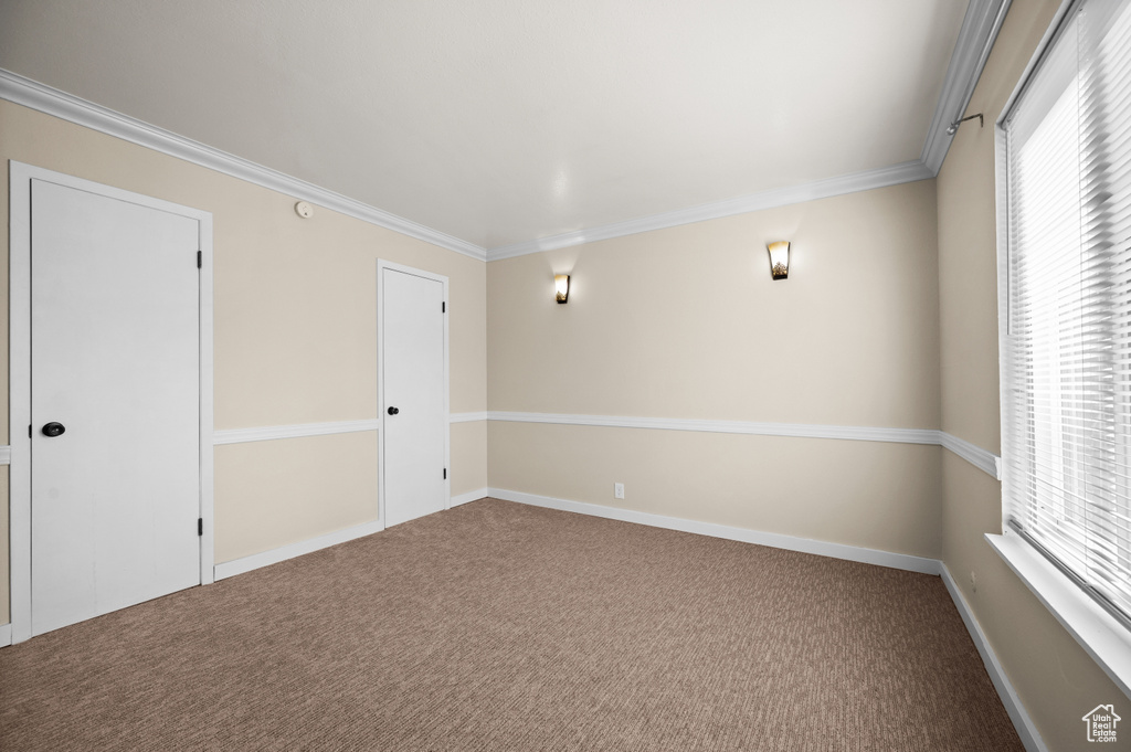 Carpeted spare room with ornamental molding