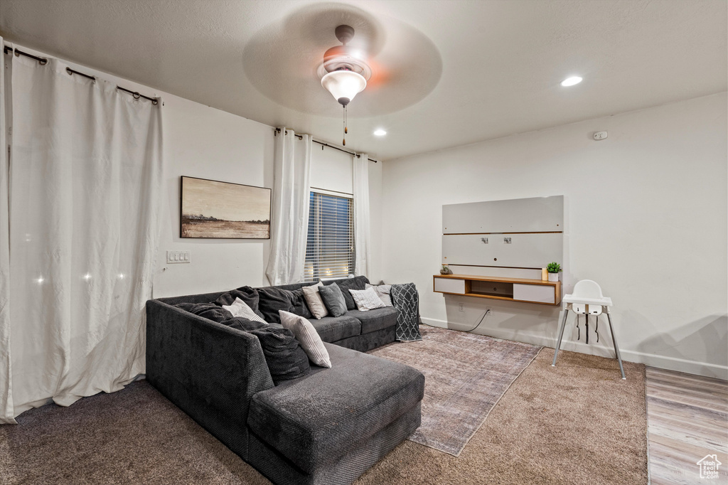 Living room with ceiling fan and wood-type flooring