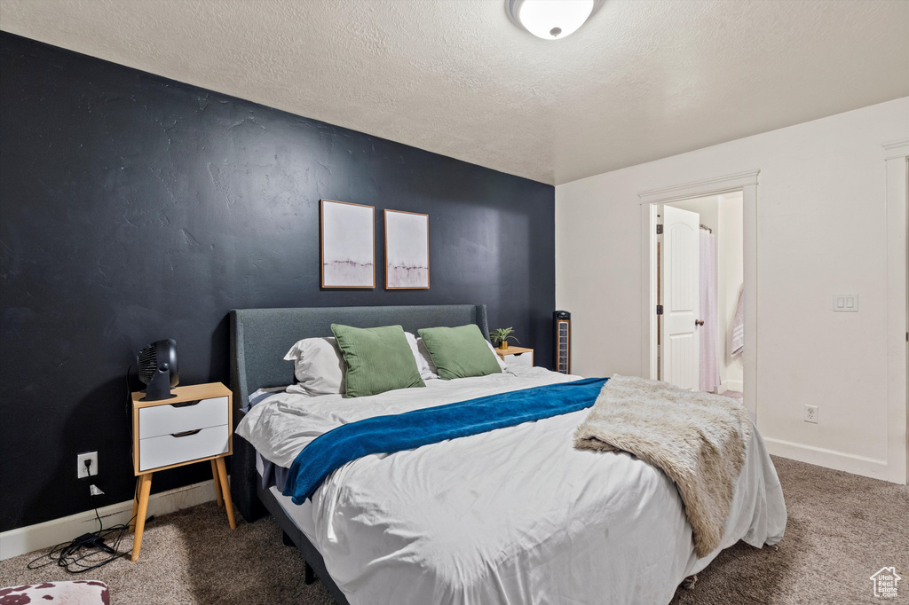 Bedroom with carpet and a textured ceiling