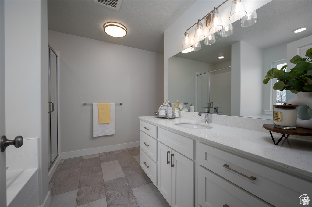 Bathroom with vanity and separate shower and tub