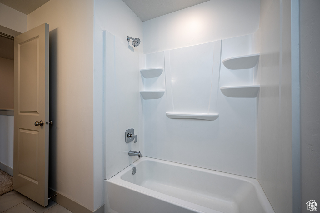 Bathroom with shower / bathing tub combination and tile patterned floors