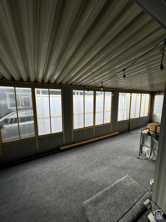 Unfurnished sunroom featuring plenty of natural light