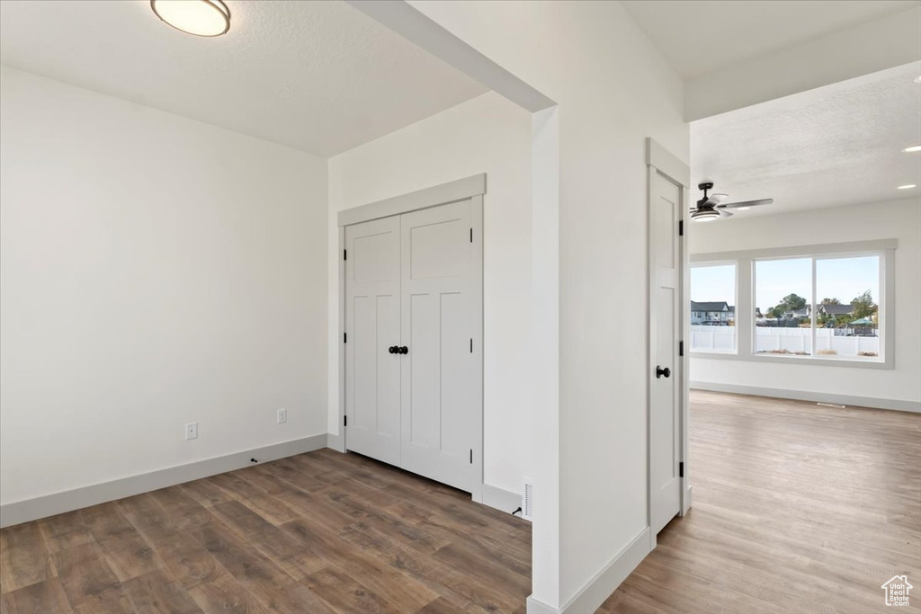 Unfurnished bedroom featuring hardwood / wood-style floors, a textured ceiling, and ceiling fan