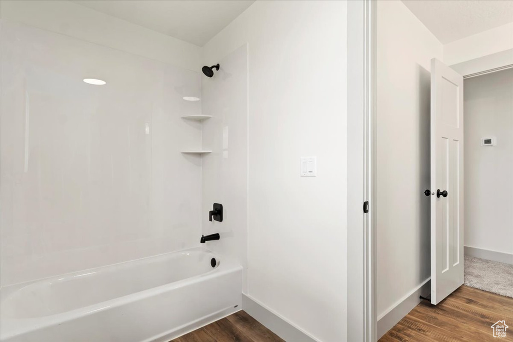 Bathroom featuring shower / washtub combination and hardwood / wood-style floors