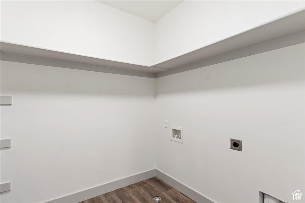 Laundry room with hookup for an electric dryer, dark wood-type flooring, and washer hookup