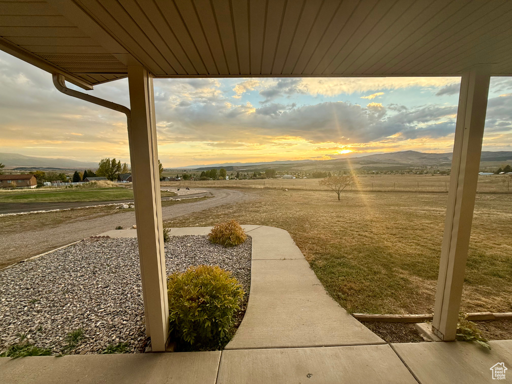 Yard at dusk featuring a mountain view