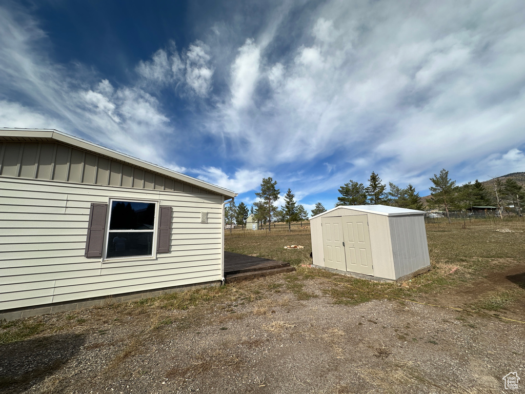 View of property exterior with a storage shed