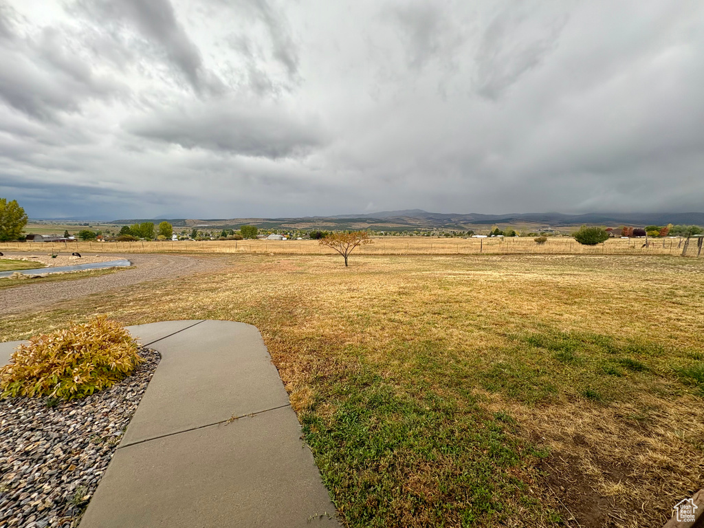 View of yard with a mountain view and a rural view