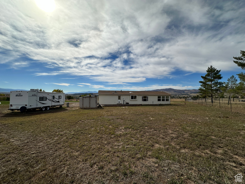 View of yard with a mountain view and a shed