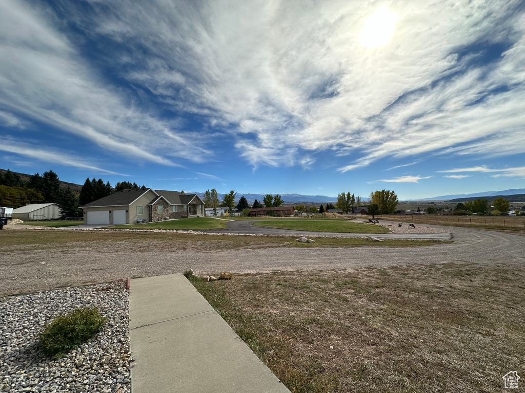 View of yard with a mountain view and a garage