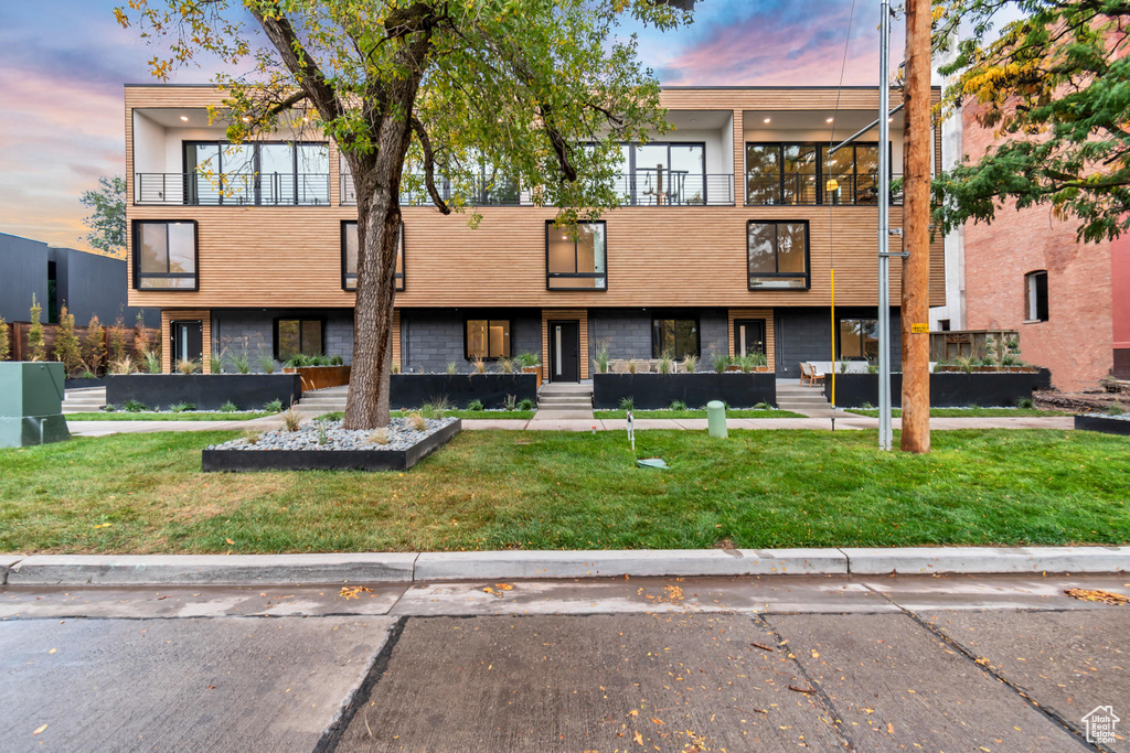 Exterior space featuring a lawn and a balcony