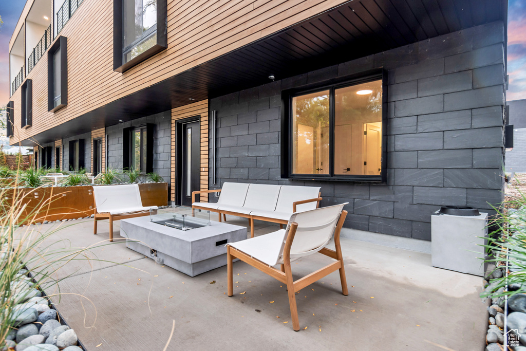 Patio terrace at dusk featuring a fire pit