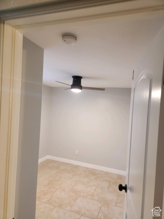 Tiled spare room with ceiling fan