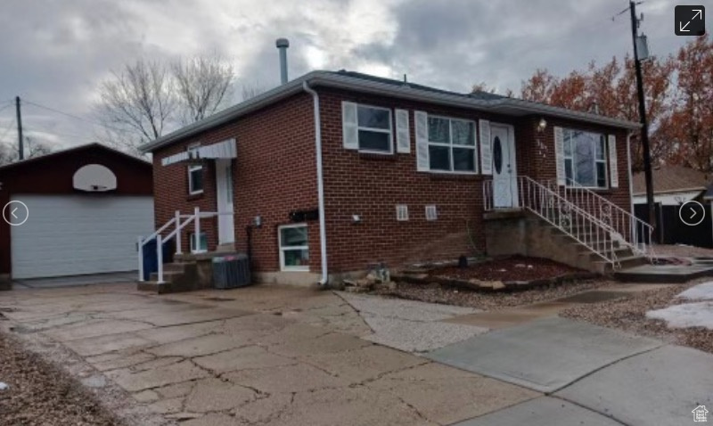 View of front of property with an outbuilding and a garage