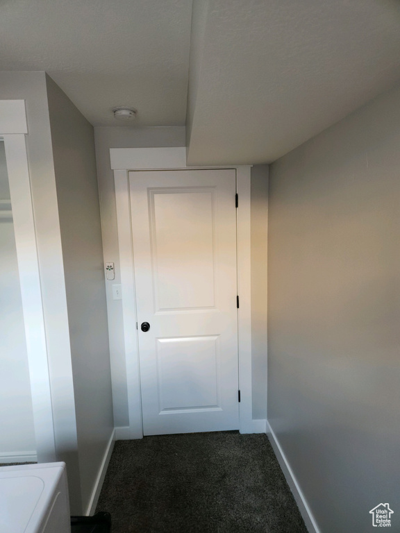 Hallway with dark colored carpet