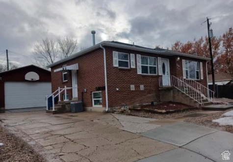 View of front facade with an outdoor structure and a garage