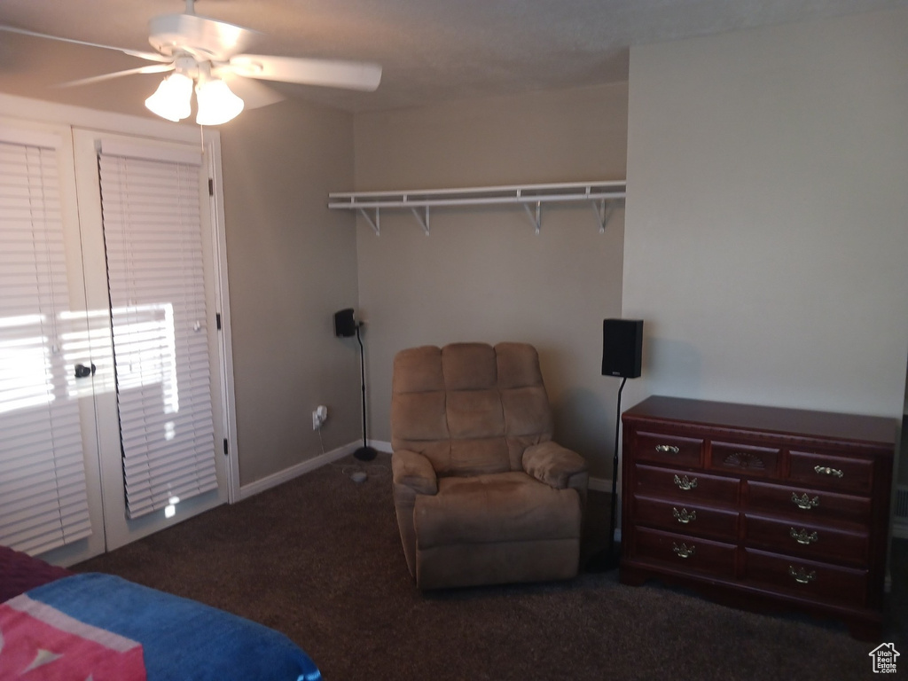 Bedroom featuring dark carpet, a closet, and ceiling fan