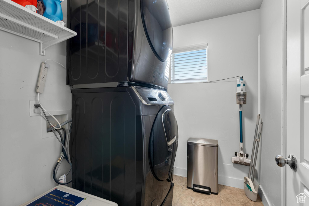 Laundry room featuring stacked washer / drying machine