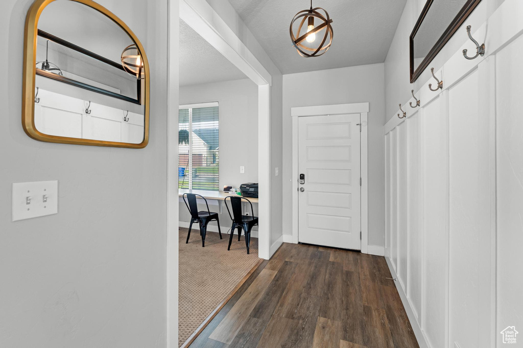 Interior space featuring a textured ceiling and dark hardwood / wood-style floors