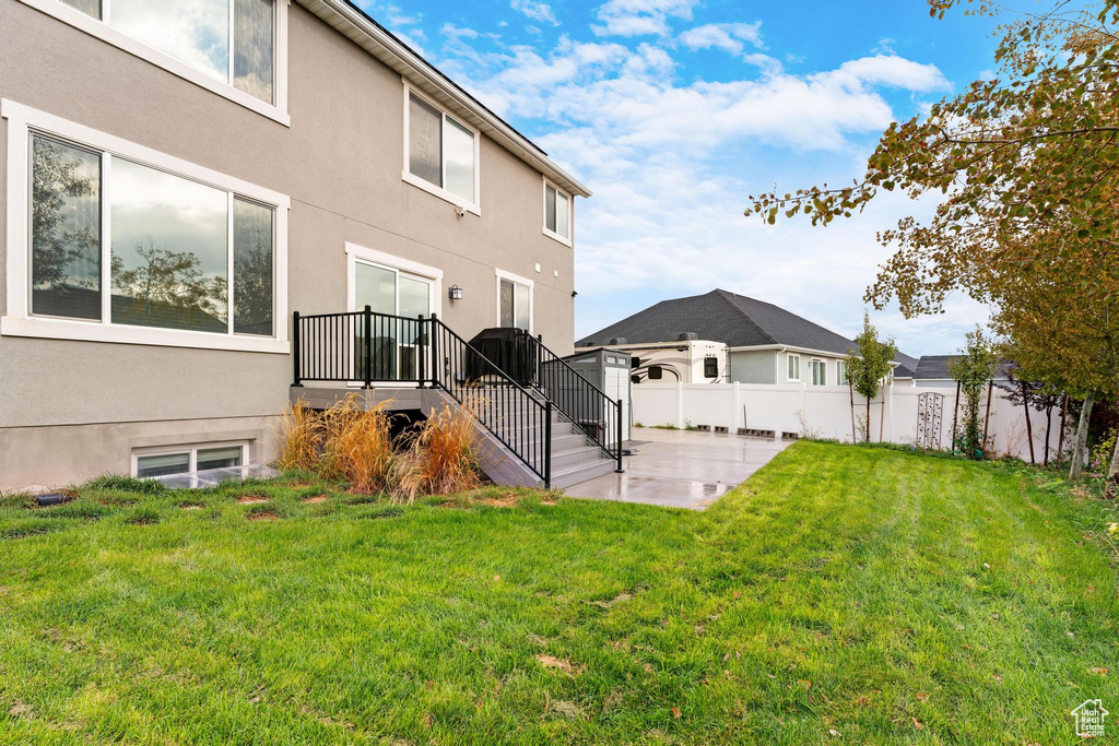 Back of property with a patio area and a yard