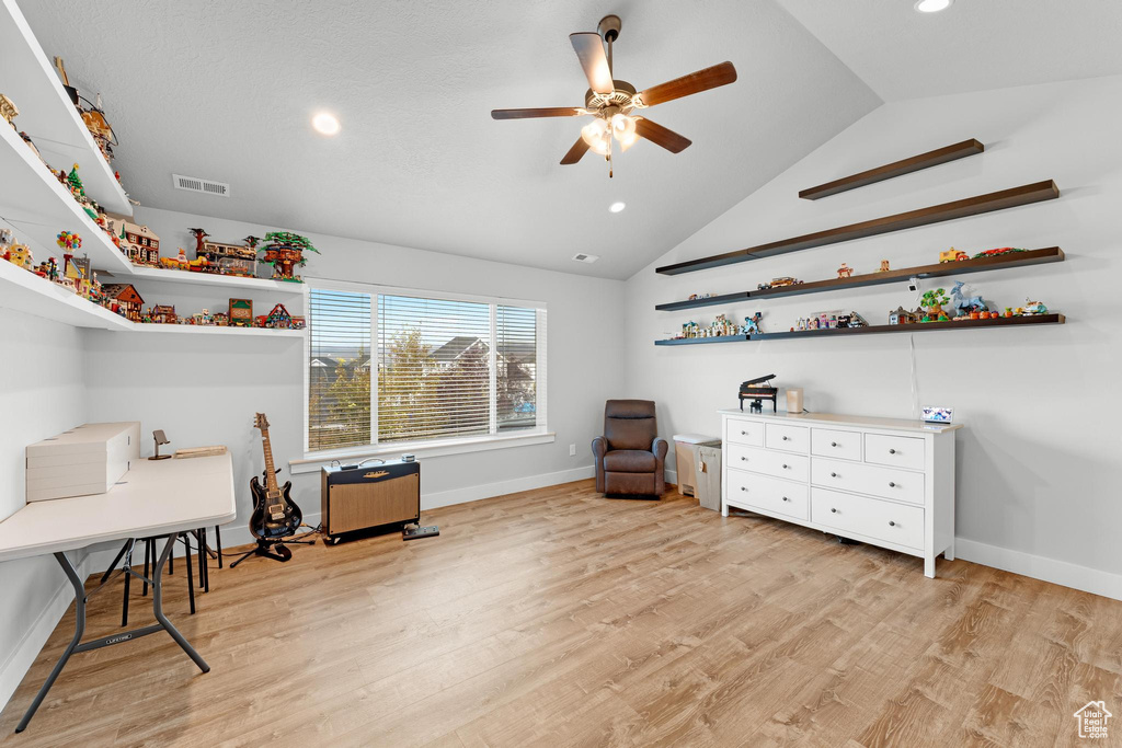 Sitting room with light hardwood / wood-style flooring, vaulted ceiling, and ceiling fan