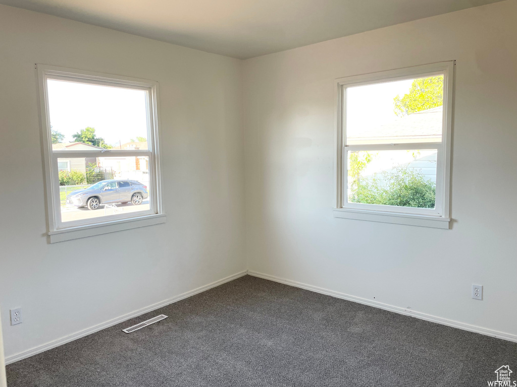 Carpeted empty room with plenty of natural light