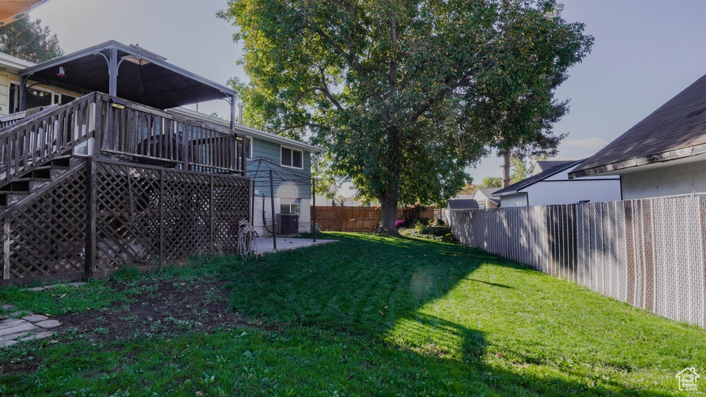 View of yard featuring a patio area, a deck, and central AC unit