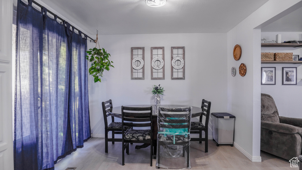 Dining room with light hardwood / wood-style floors