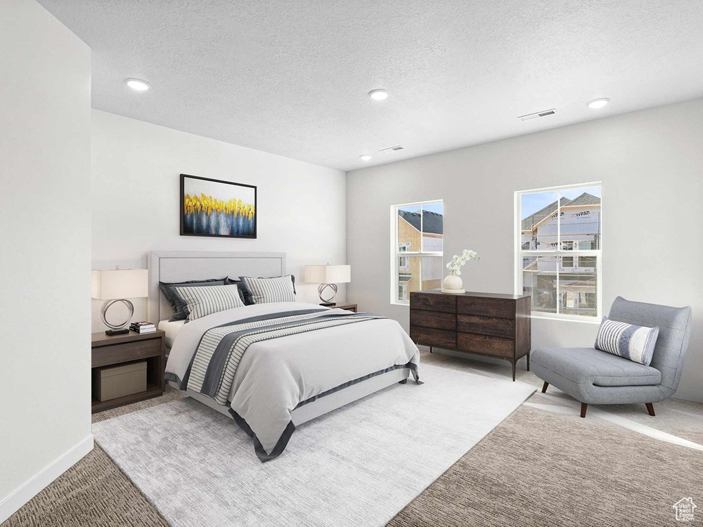 Bedroom featuring a textured ceiling and carpet floors