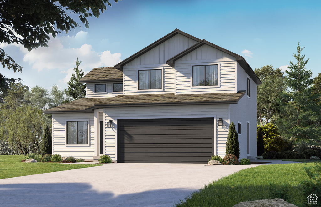 View of front of home with a garage and a front lawn