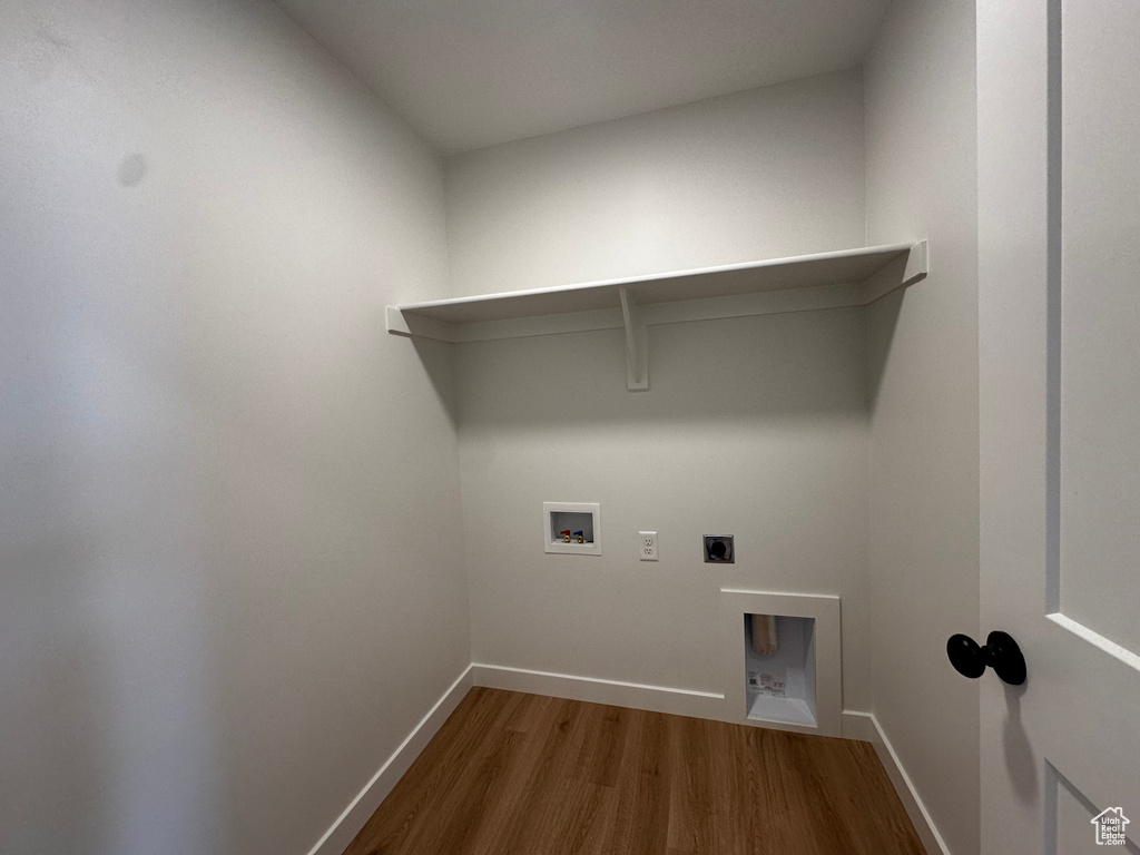 Clothes washing area with hookup for an electric dryer, hardwood / wood-style floors, and washer hookup