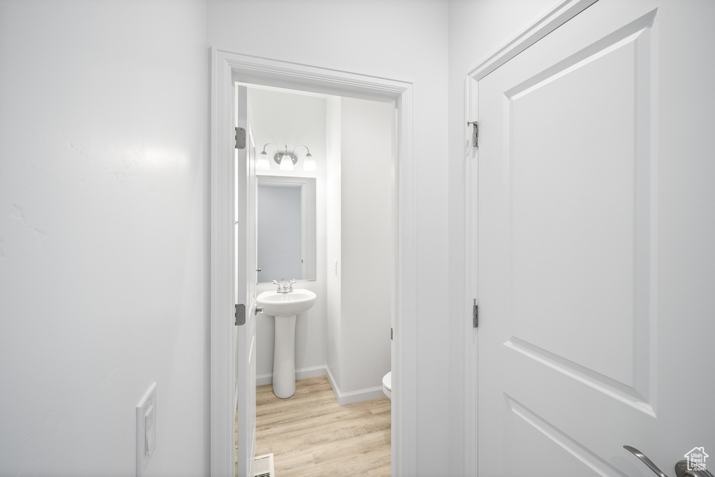 Bathroom featuring sink, hardwood / wood-style flooring, and toilet