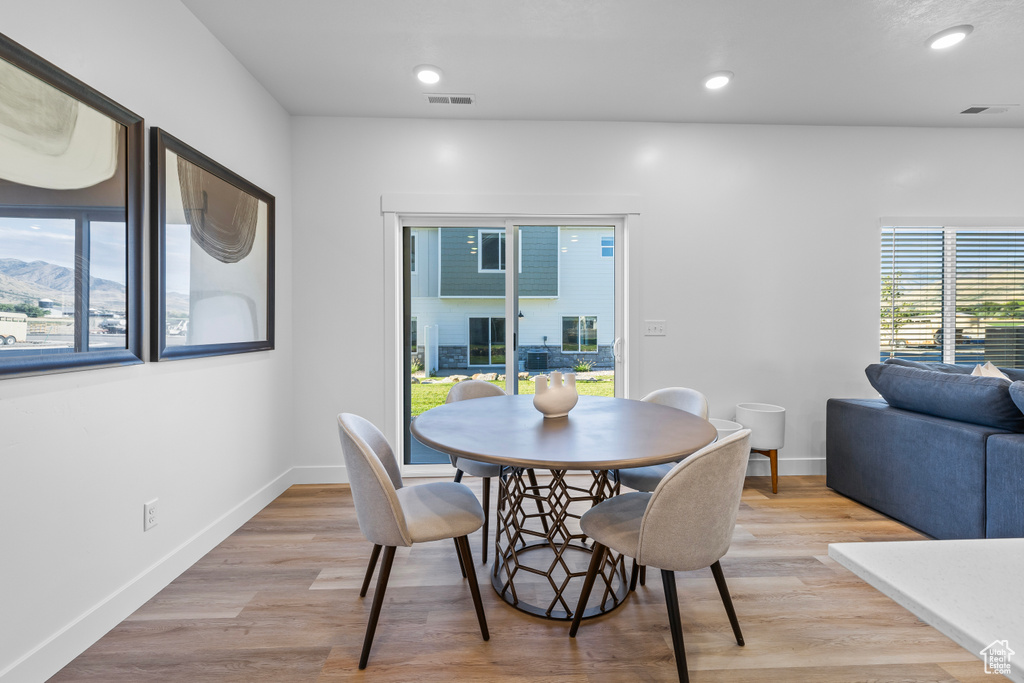 Dining area with light hardwood / wood-style floors