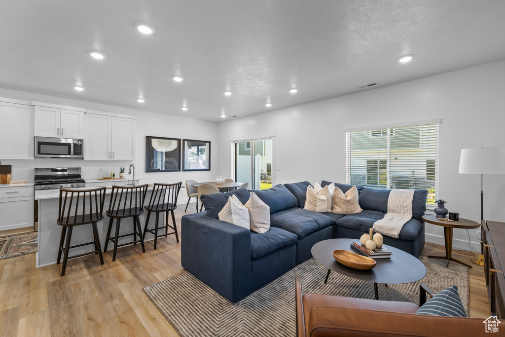 Living room with light wood-type flooring