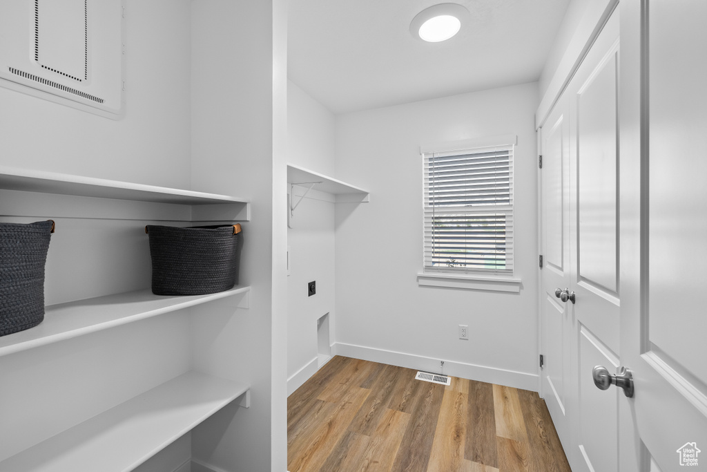 Washroom with light hardwood / wood-style flooring