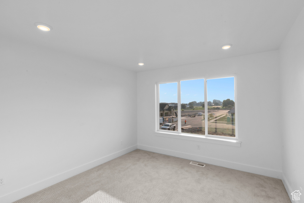 Unfurnished room with light colored carpet