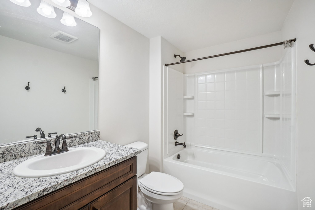 Full bathroom featuring vanity, tile patterned flooring, toilet, and shower / bath combination