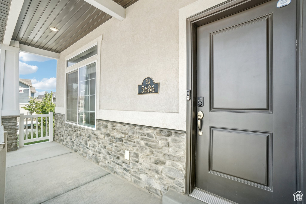 View of exterior entry with covered porch