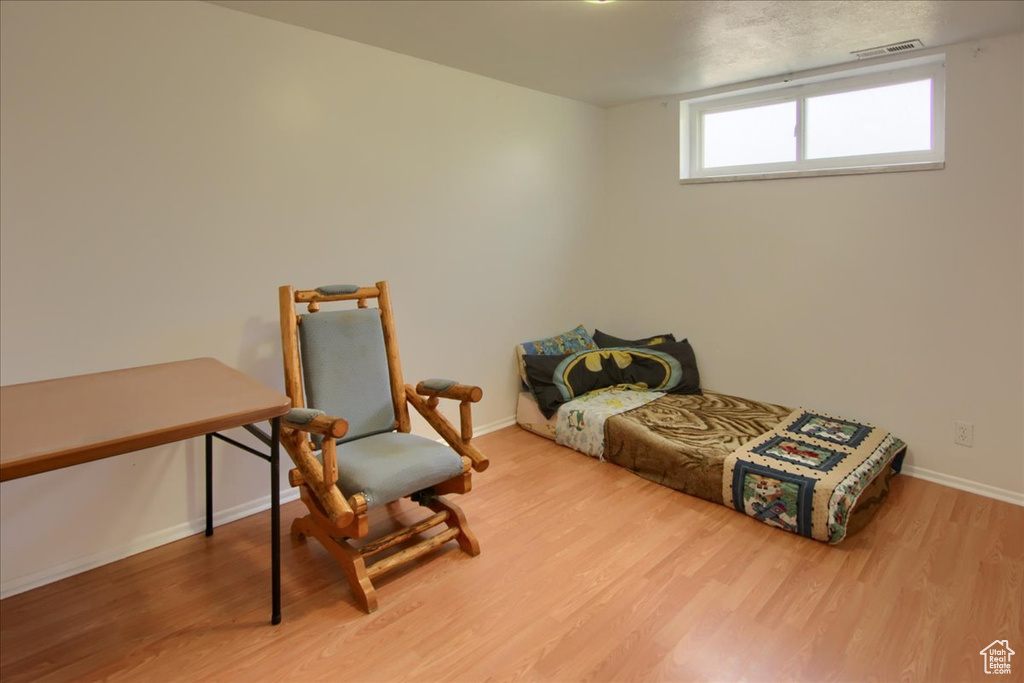 Bedroom with hardwood / wood-style floors