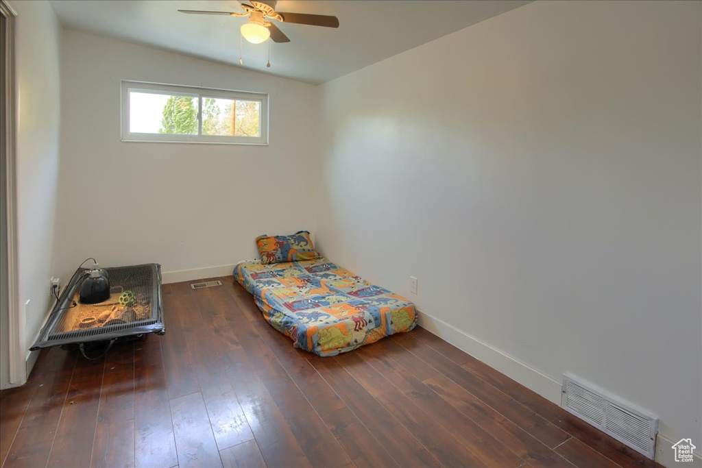 Bedroom featuring lofted ceiling, dark hardwood / wood-style floors, and ceiling fan