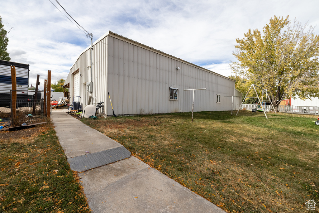 View of side of home with a lawn