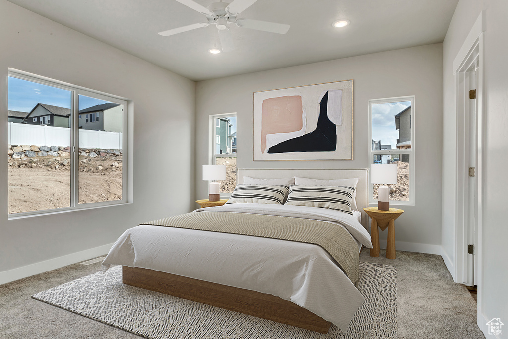 Carpeted bedroom with ceiling fan