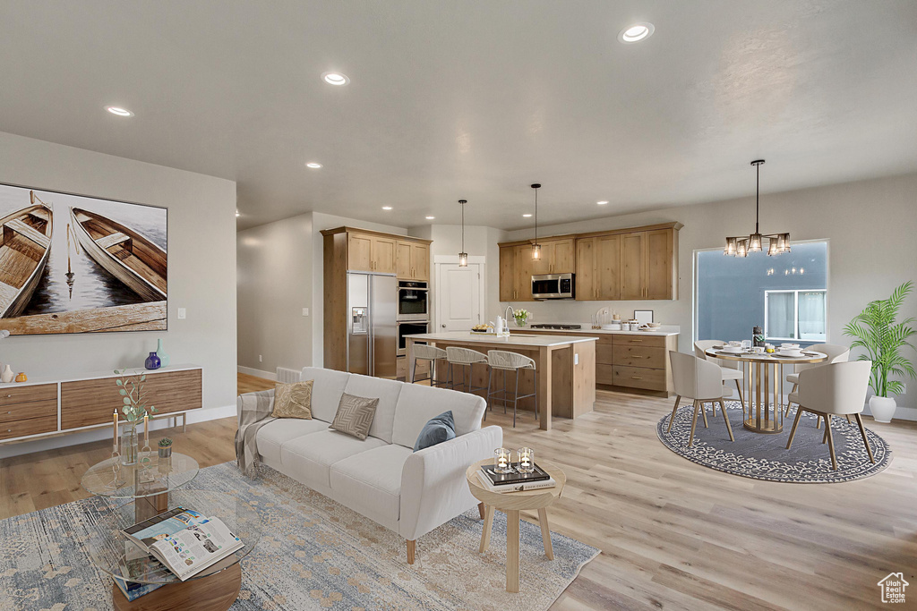 Living room featuring light hardwood / wood-style flooring and a notable chandelier