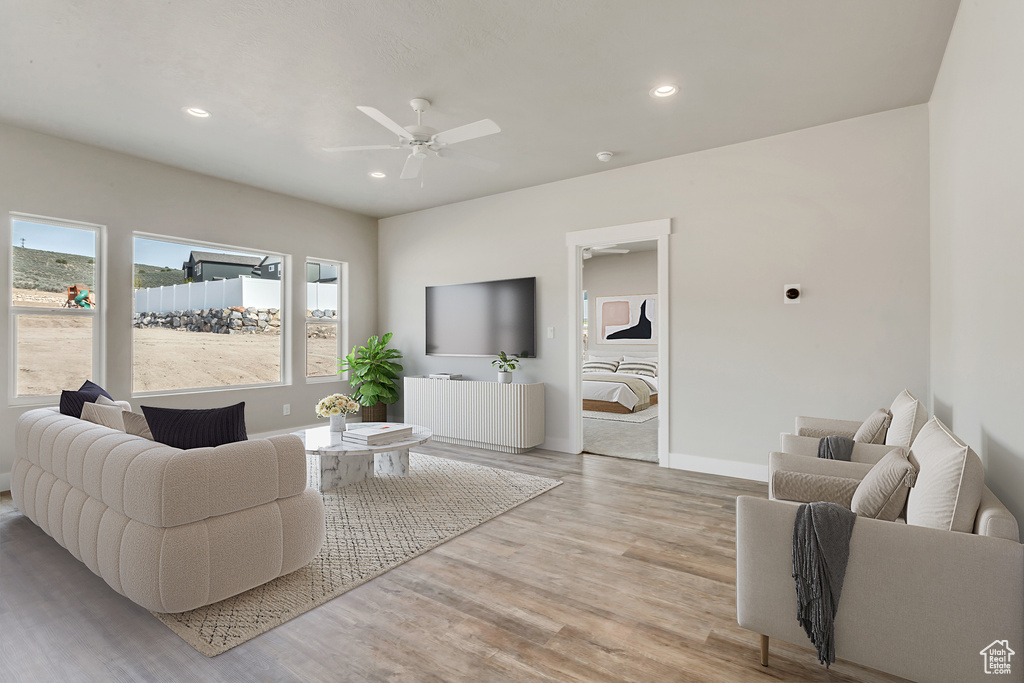 Living room featuring light hardwood / wood-style flooring and ceiling fan