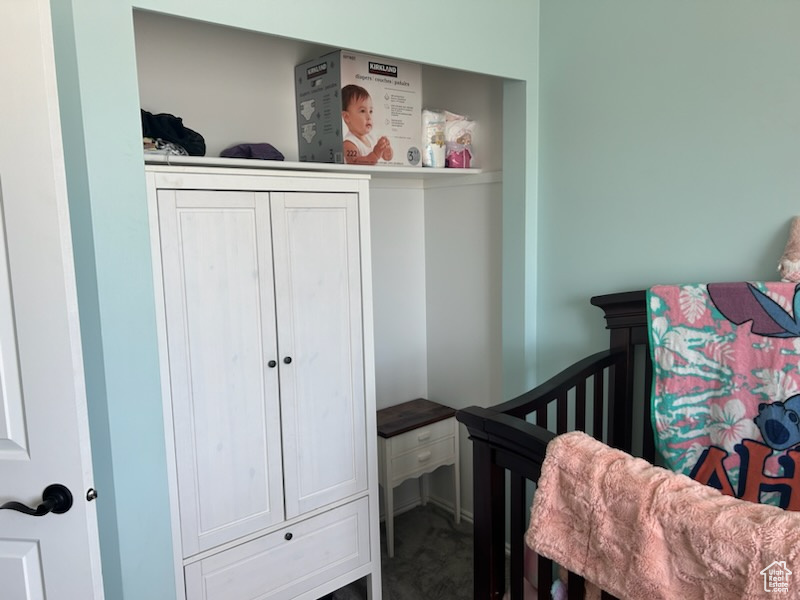 Bedroom featuring a closet and a nursery area