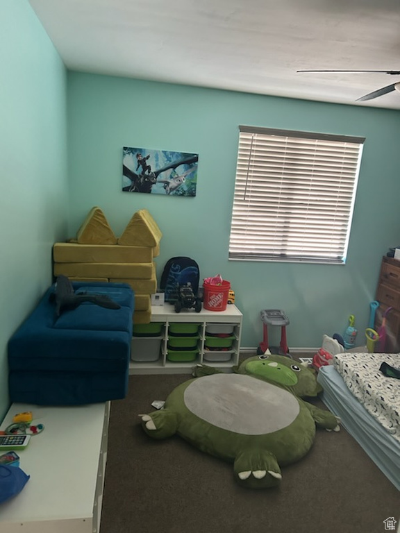 Carpeted bedroom featuring ceiling fan