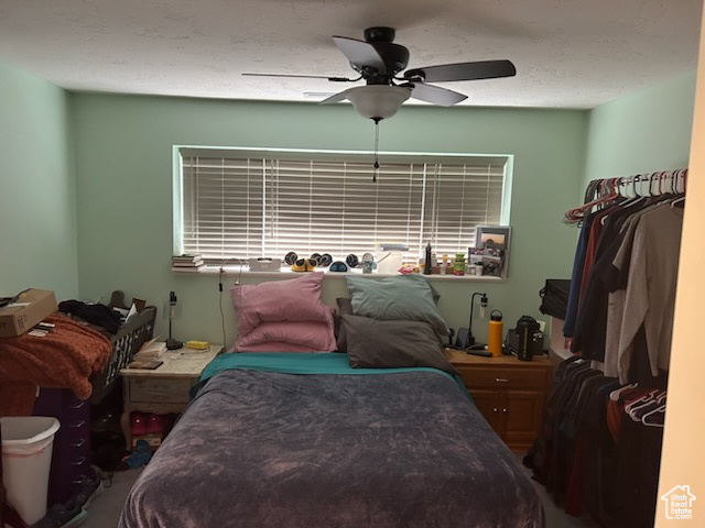 Bedroom featuring a textured ceiling and ceiling fan